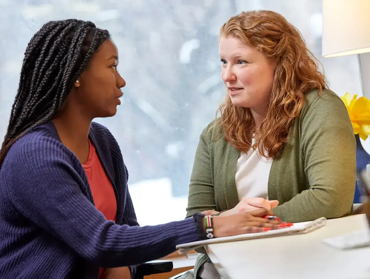 Two women talking face to face