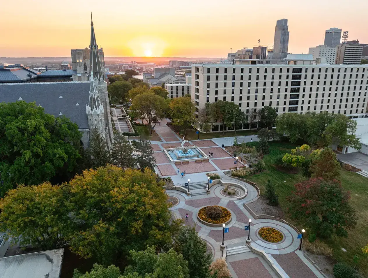 Bird's eye view of Creighton campus mall walkway with sunrise on horizon.