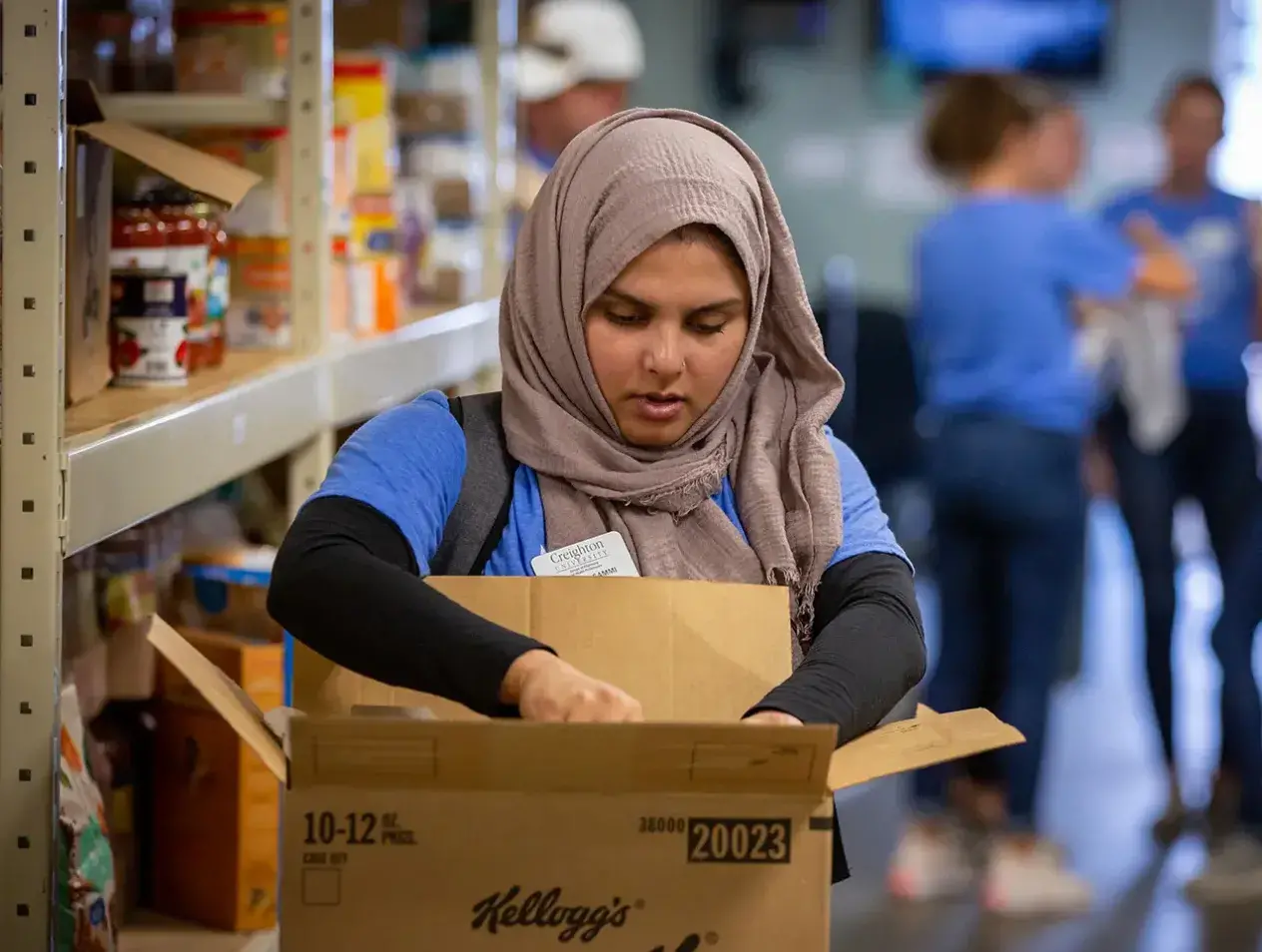 Woman opening large cardboard box