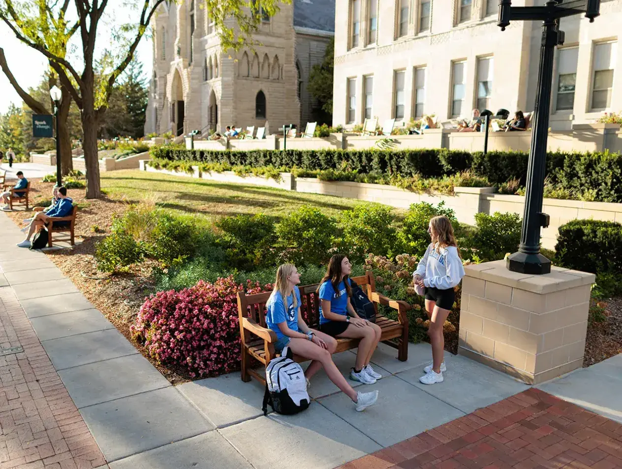 Students gathered on bench alongside Creighton mall.