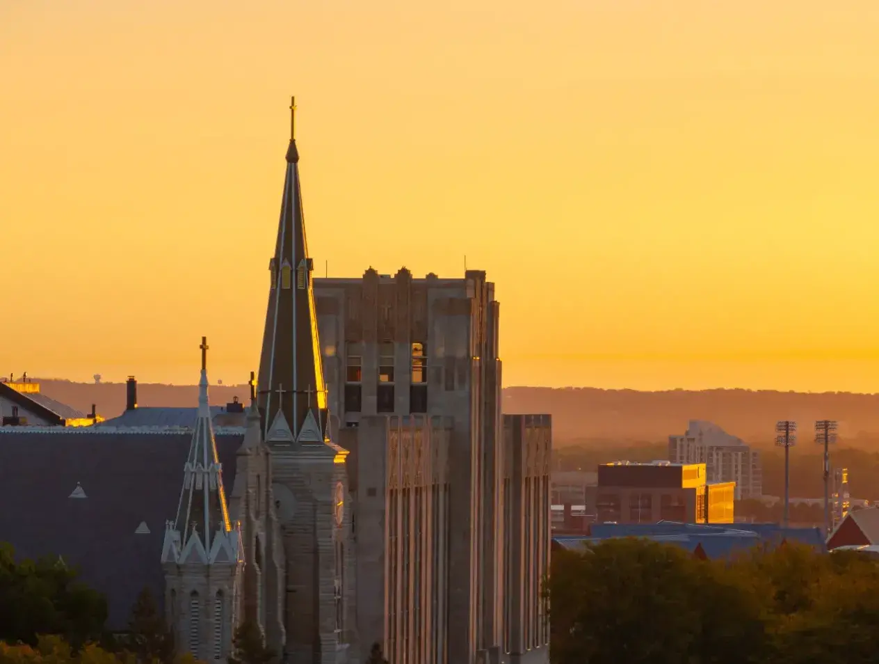 Yellow sunrise coloring St. John's church steeple.