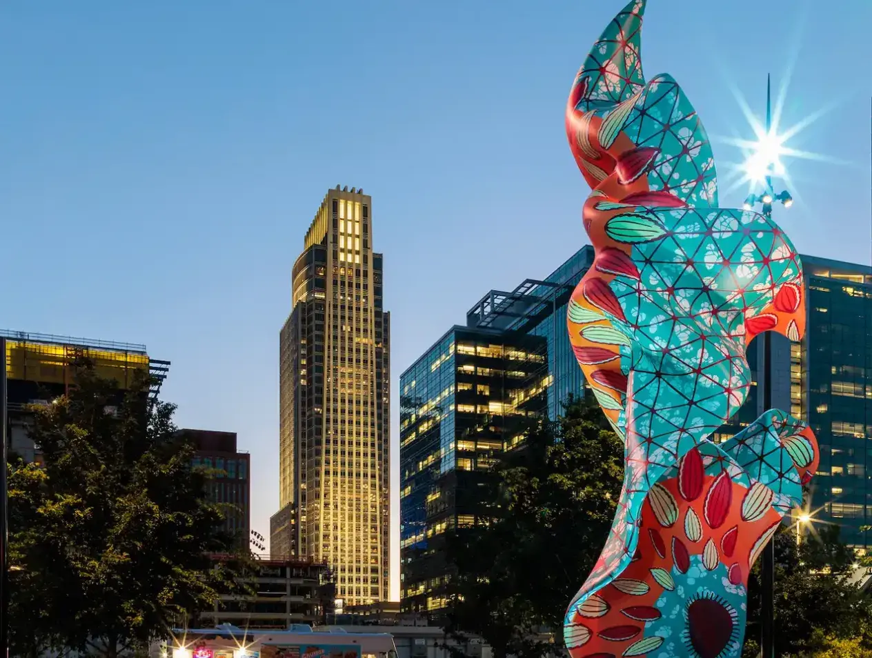 Downtown Omaha at twilight featuring colorful sculpture.