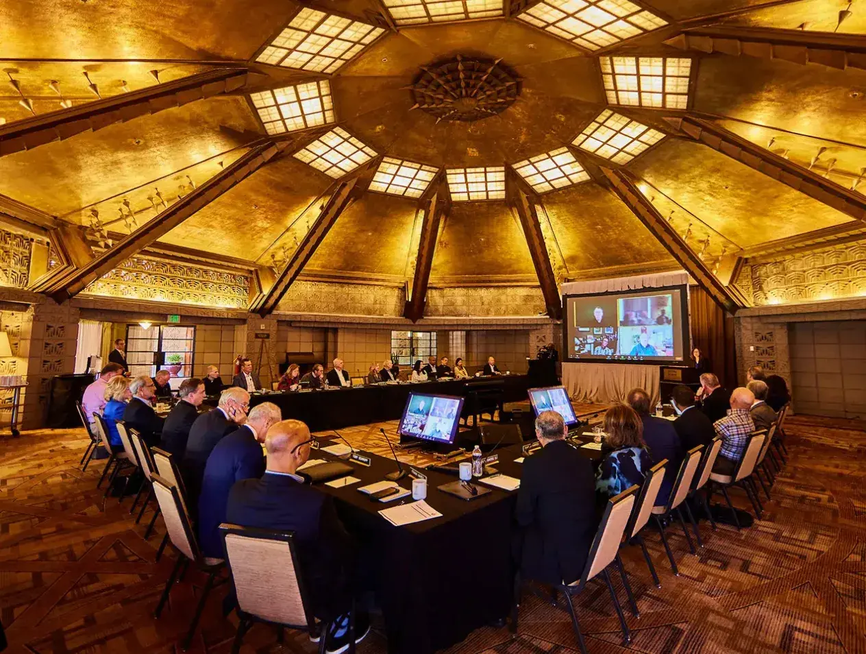Wide angle view of Creighton leadership in meeting area.