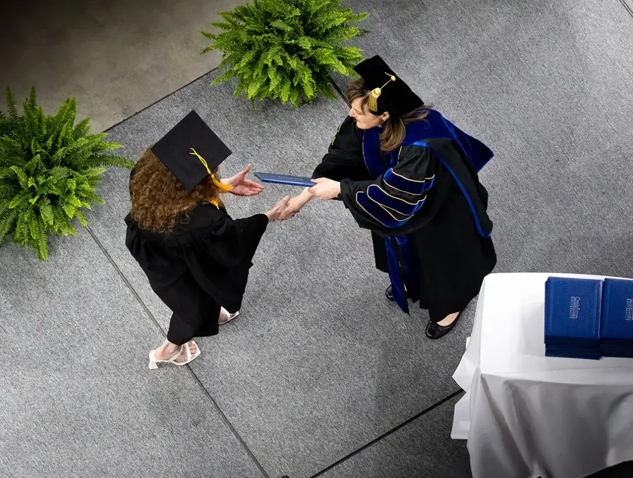 Overhead shot of student crossing commencement stage