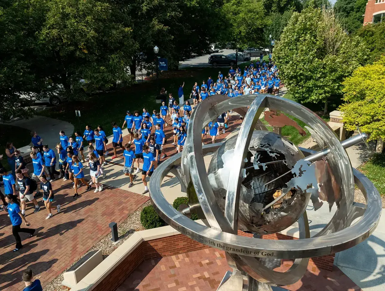 Drone shot from above of students walking past Harper Center.