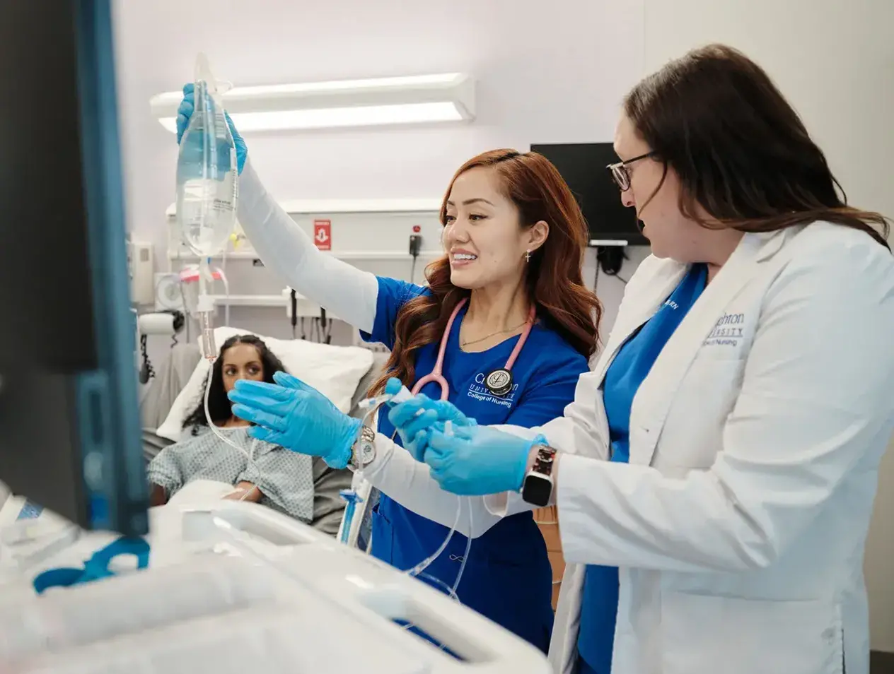 Nursing students inspecting computer data.