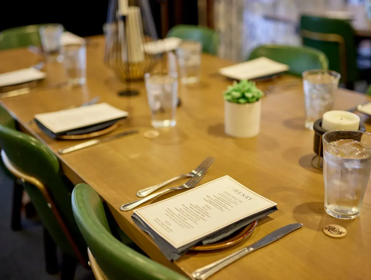 Table set for a fancy dinner with a menu on the center plate
