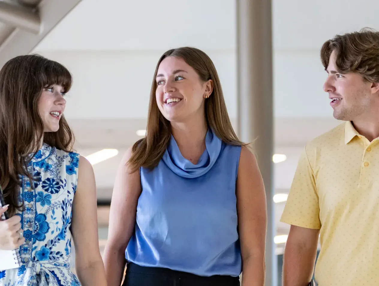 Three students walking and talking