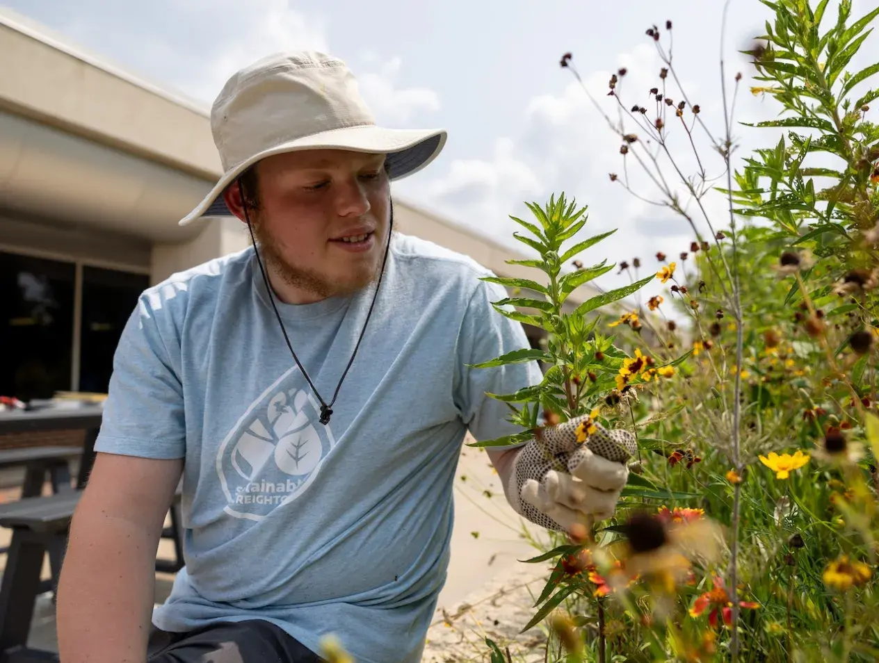 Student in a flower garden.
