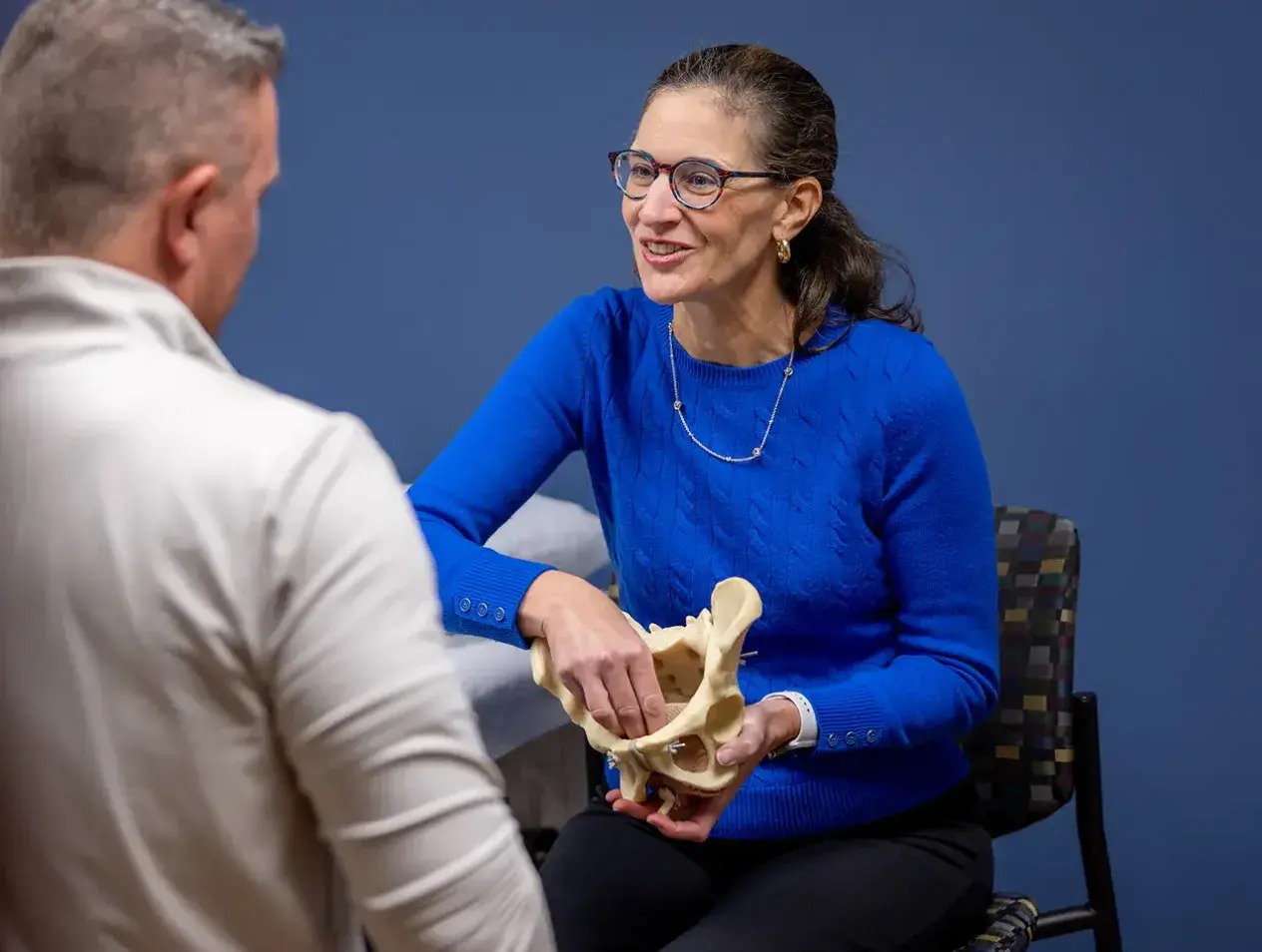 Faculty looking at skeletal models