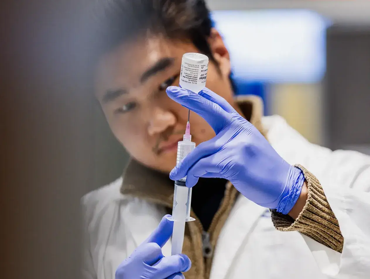 Health Sciences student filling syringe