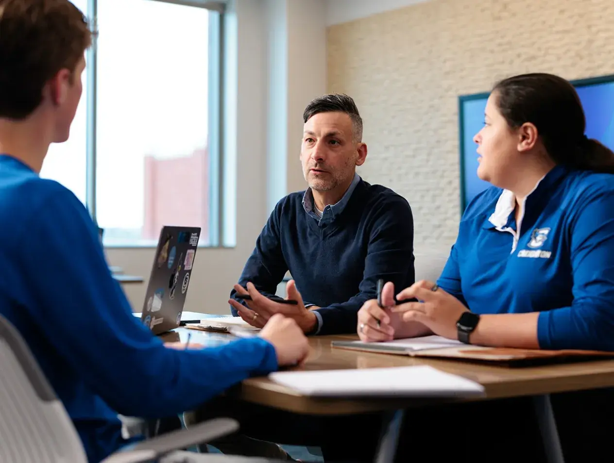 Students discussing with Nathan Preheim