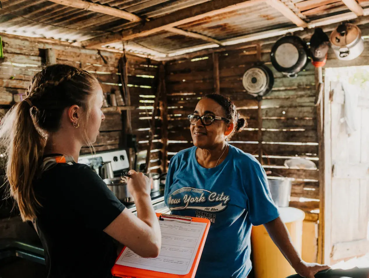 Student talking to a woman in the Dominican Republic.