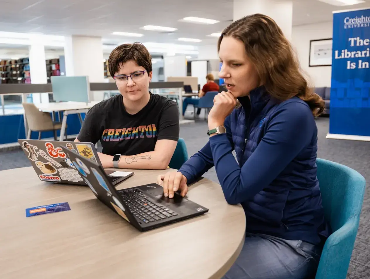 Librarians consulting on computers