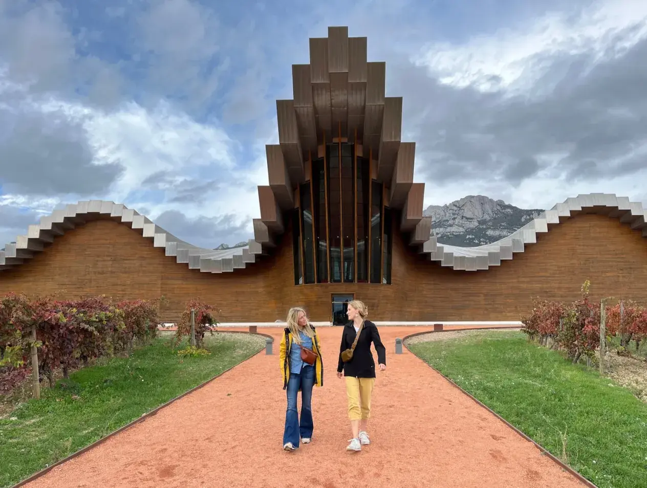 Two students in front of an architectural building