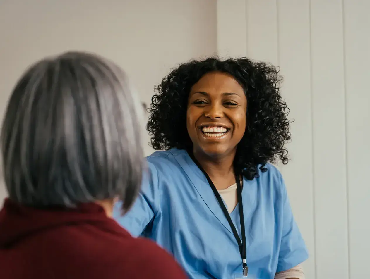 Doctor smiling and speaking to a patient.