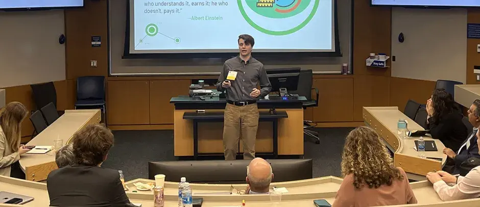 Jack Sutton giving financial presentation in classroom.