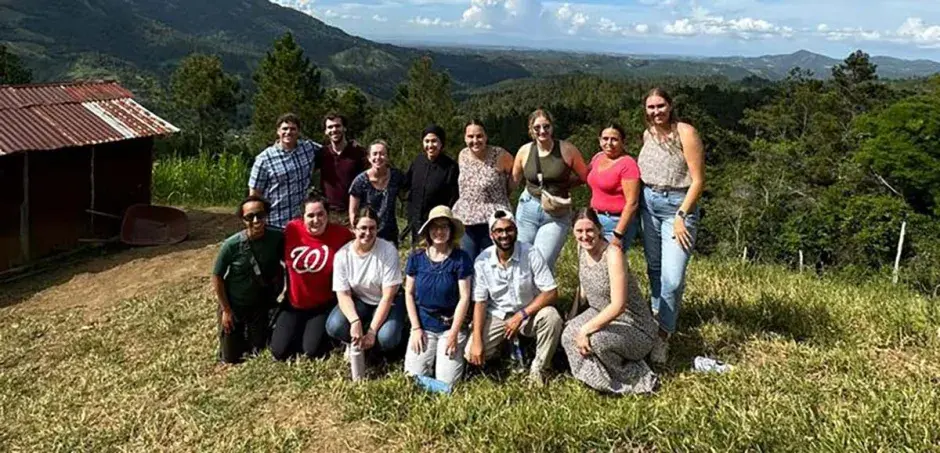 Arrupe Scholars group amidst rolling hills.