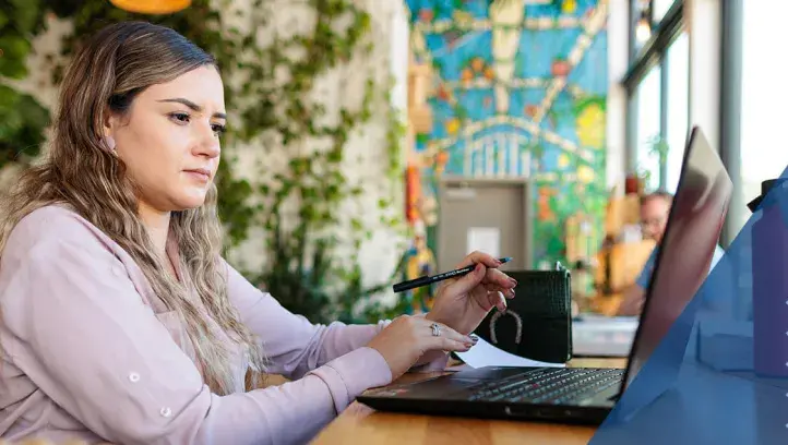 Young woman at table with laptop