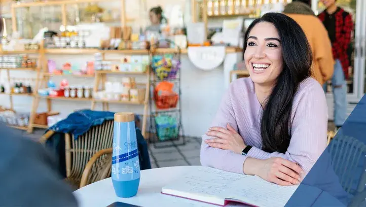Young woman at table smiling