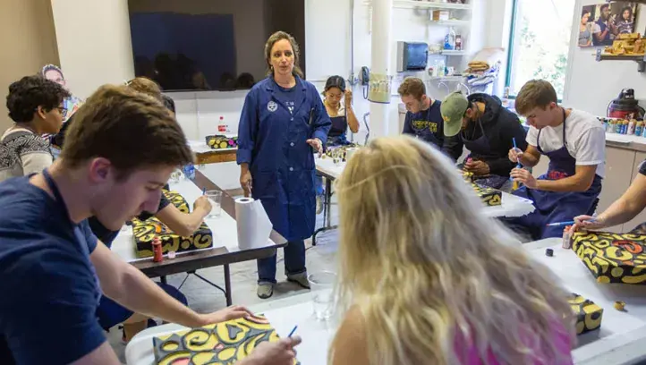 Students working on art project in class setting.