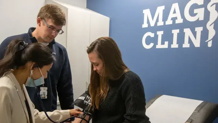 Take patient blood pressure at Magis Clinic.