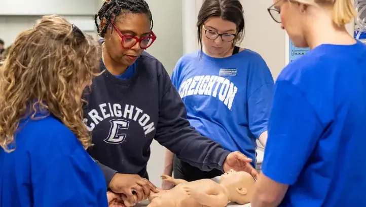 Nursing educational class working on infant care.