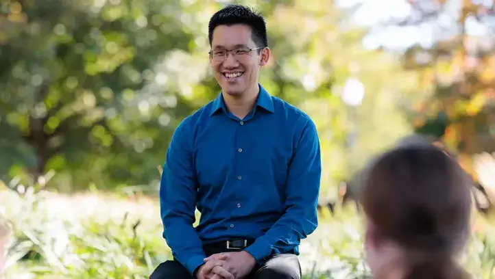 Tom Wong discussing material outside with students.