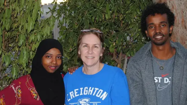 JWL student poses for picture with Creighton representative.