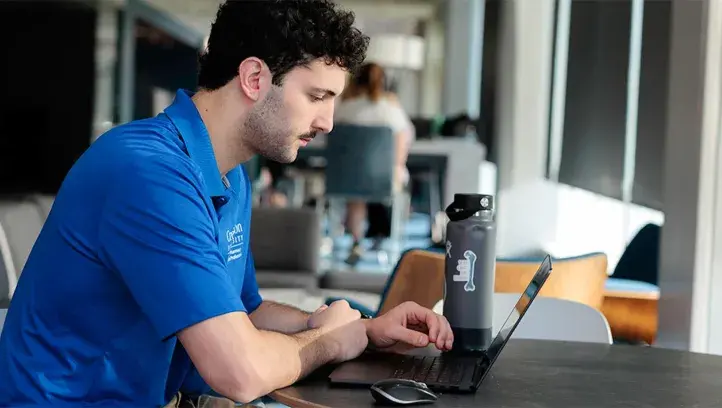 Man sitting at table and looking at computer