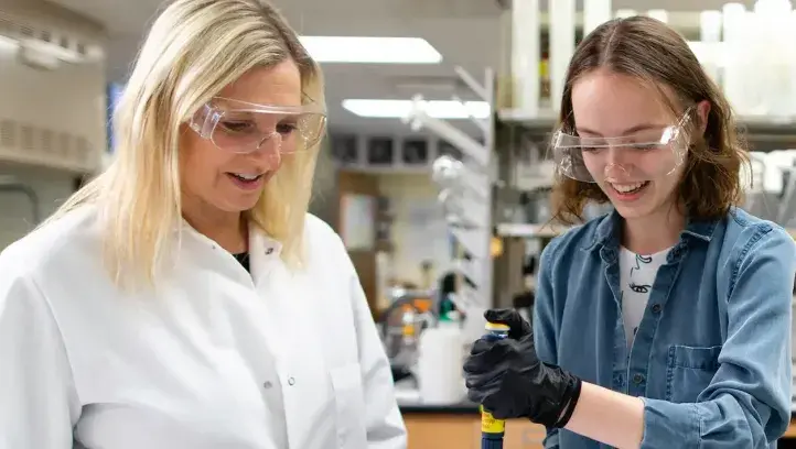 Strauss-Soukup works with student in lab setting.