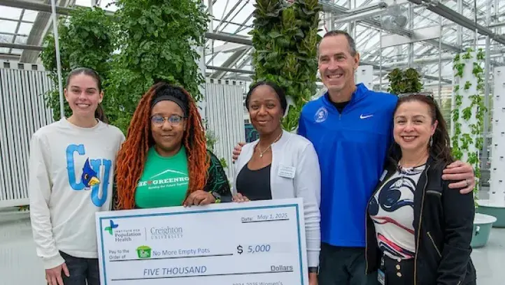 Creighton Women's Basketball and IPH donate $5,000 to No More Empty Pots