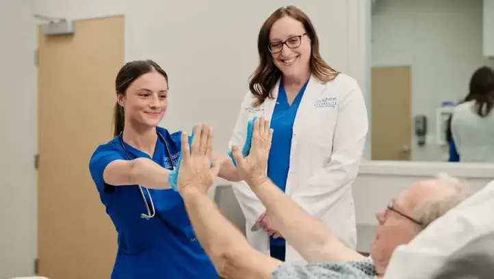Nurse celebrating with patient.