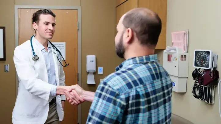 Shaking hands in doctor office.