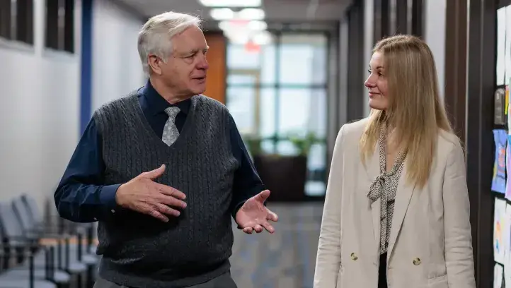 Law Professor R. Collin Mangrum, JD, SJD, and law student meet in the School of Law