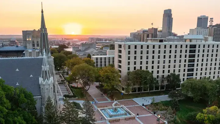 Morning skyline of Creighton campus with warm sunrise.