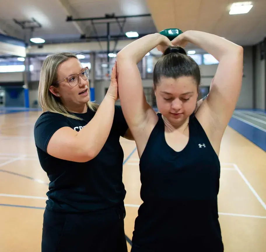Faculty and student in gym