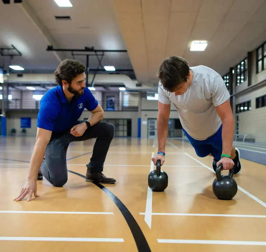 Faculty and student in gym