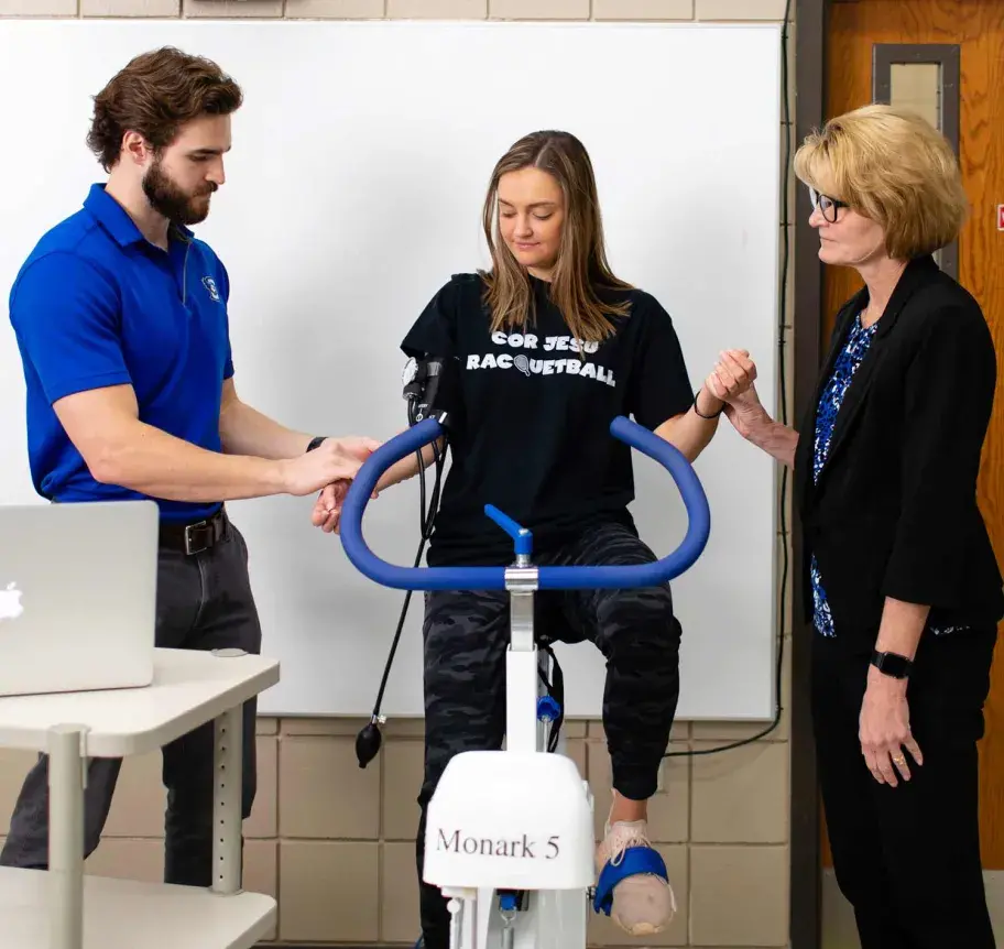 Faculty and student in gym