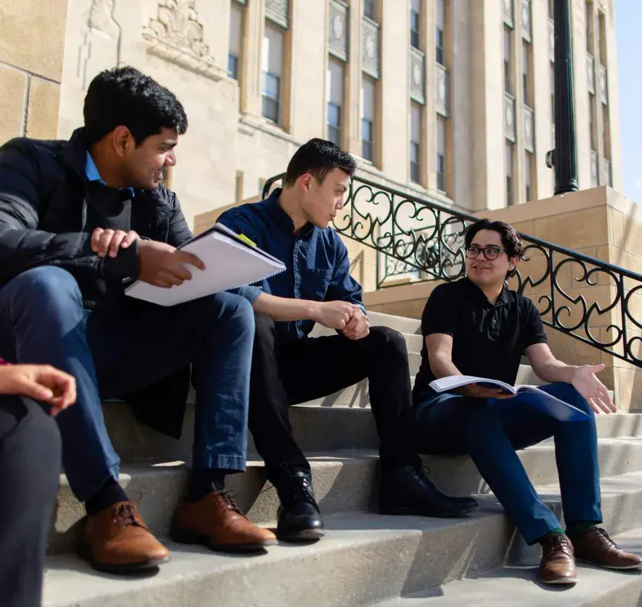 Students sitting on stairs at Creighton Hall
