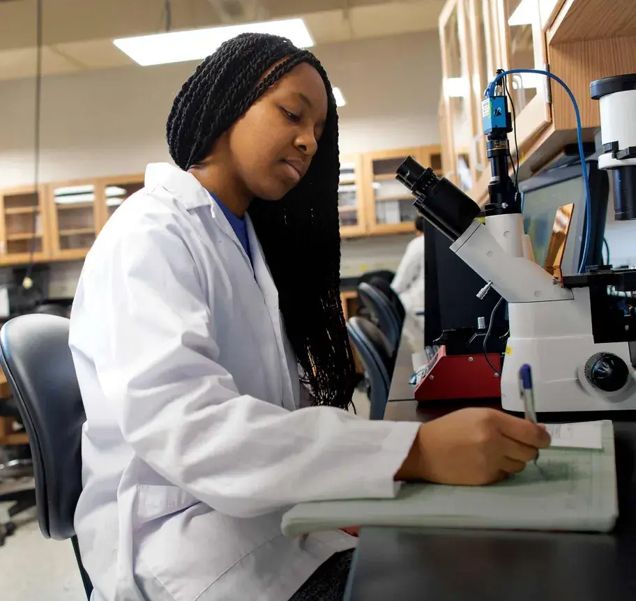 Student working at microscope