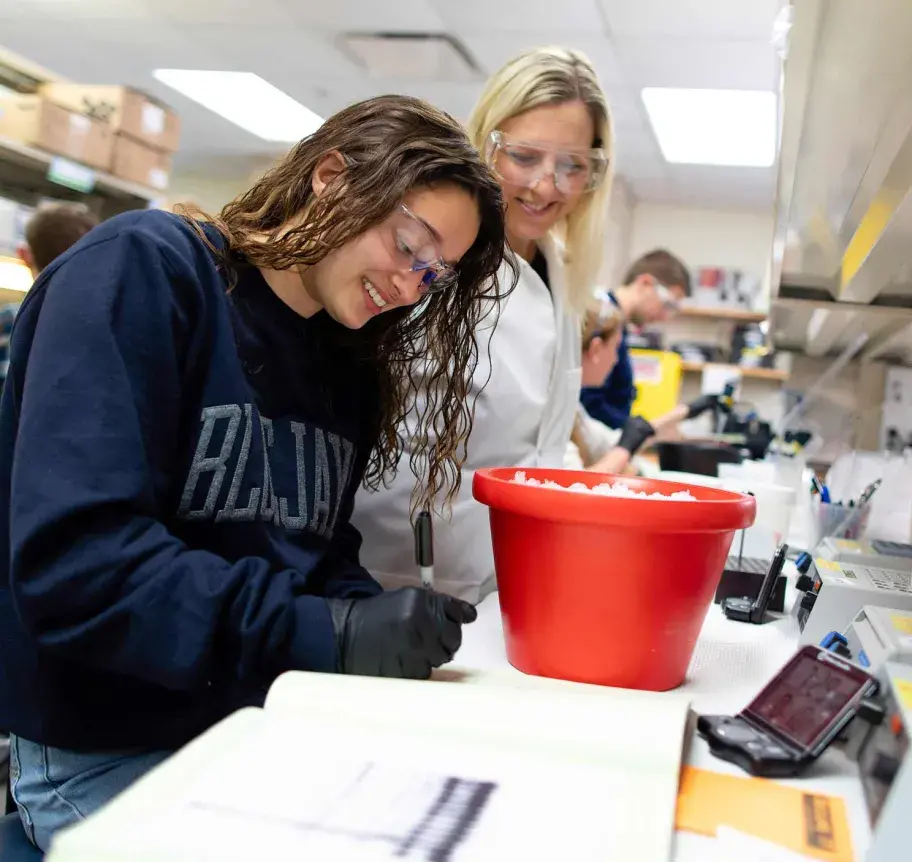 Student and faculty in lab