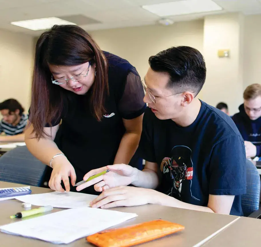 Professor helping student in class