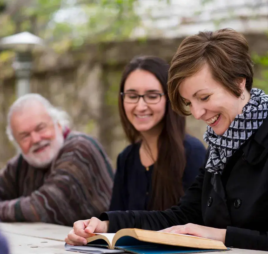 Students in book discussion outdoors