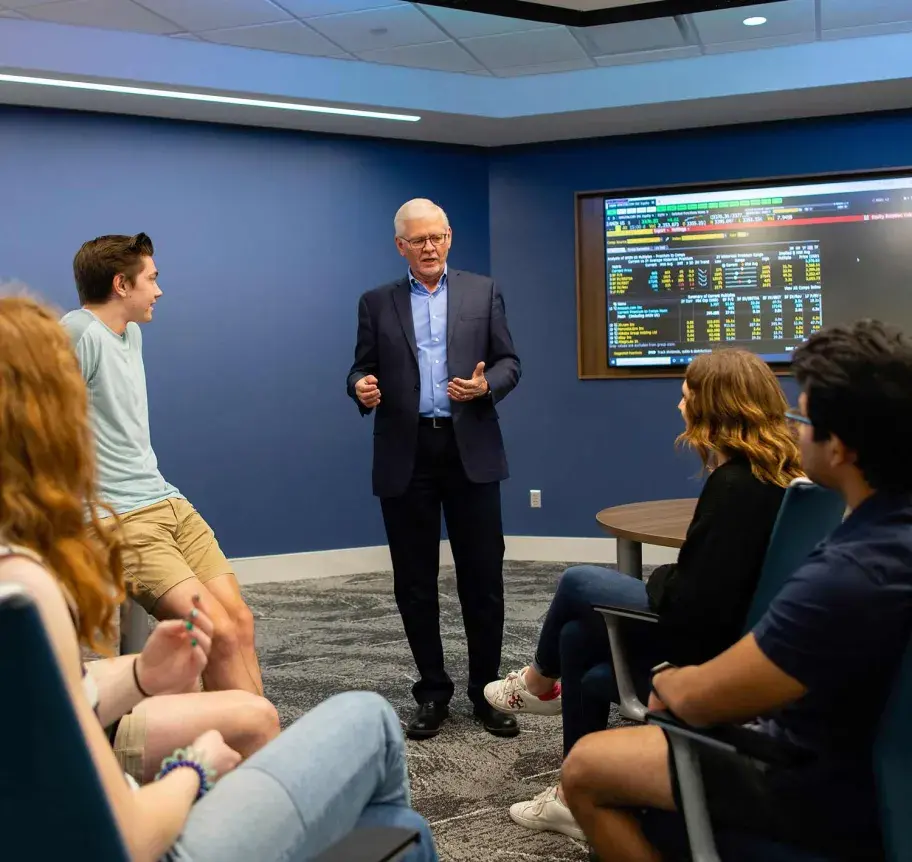 Finance faculty speaking with students