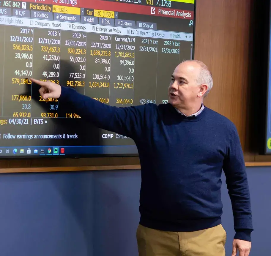 Faculty instructing students in finance class