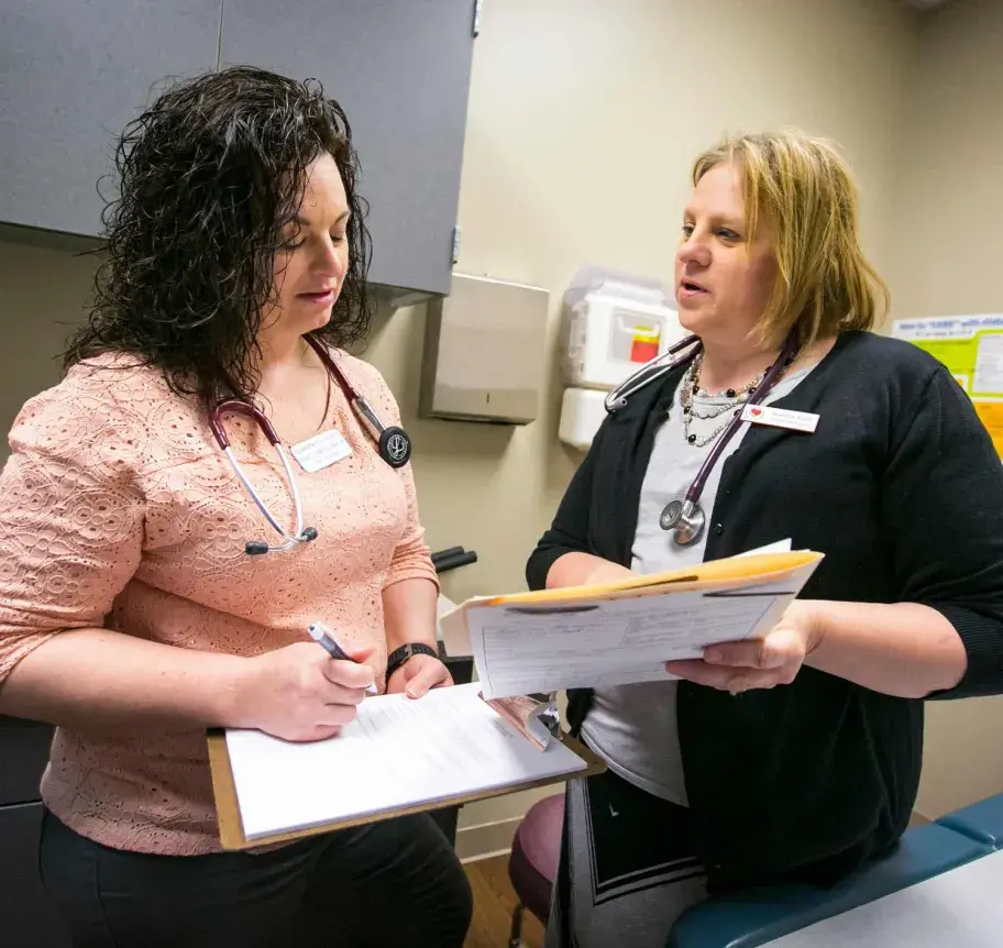 Clinic setting wtih faculty discussing patient