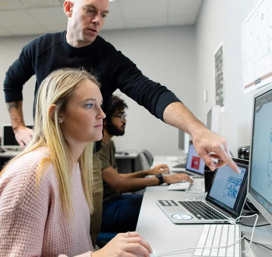 Faculty working with student at computer