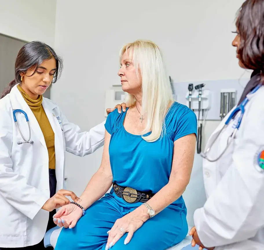 Physician assistant student and faculty working with patient