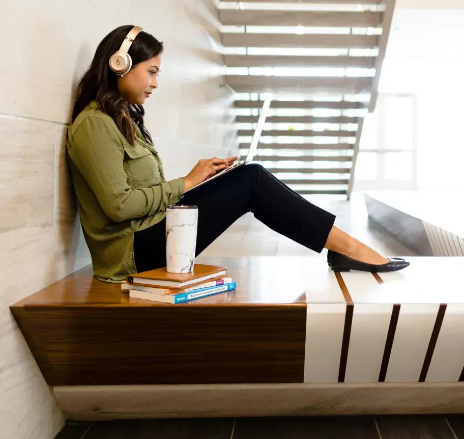 Student on laptop on Creighton campus